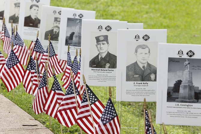 A field of flags and photos remembers some who have fallen in recent conflicts.