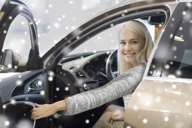 Woman in car in snowy weather