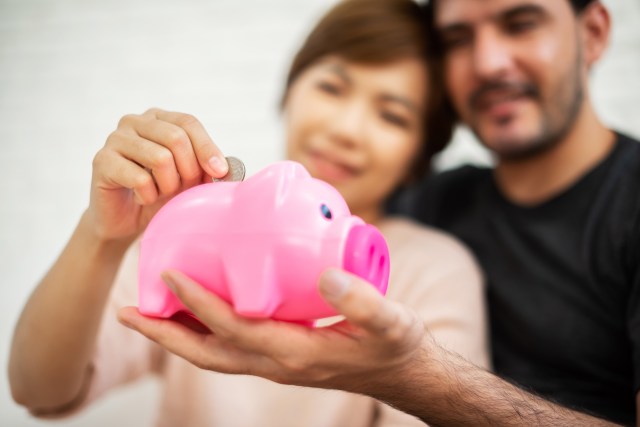 Couple saving in piggy bank