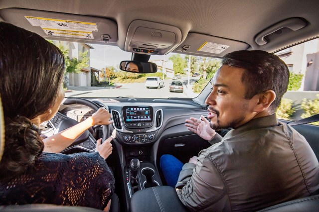 Parents in front seats of SUV