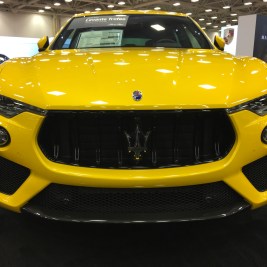 Yellow Maserati at auto show near me
