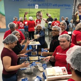 “Starving Children” volunteers in red SC T-shirts