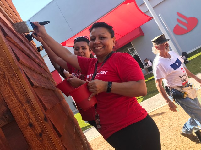 Santander volunteers painting tiny house