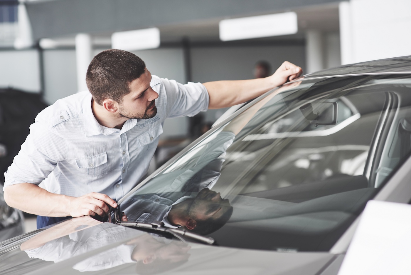 Car shopper looking at window sticker