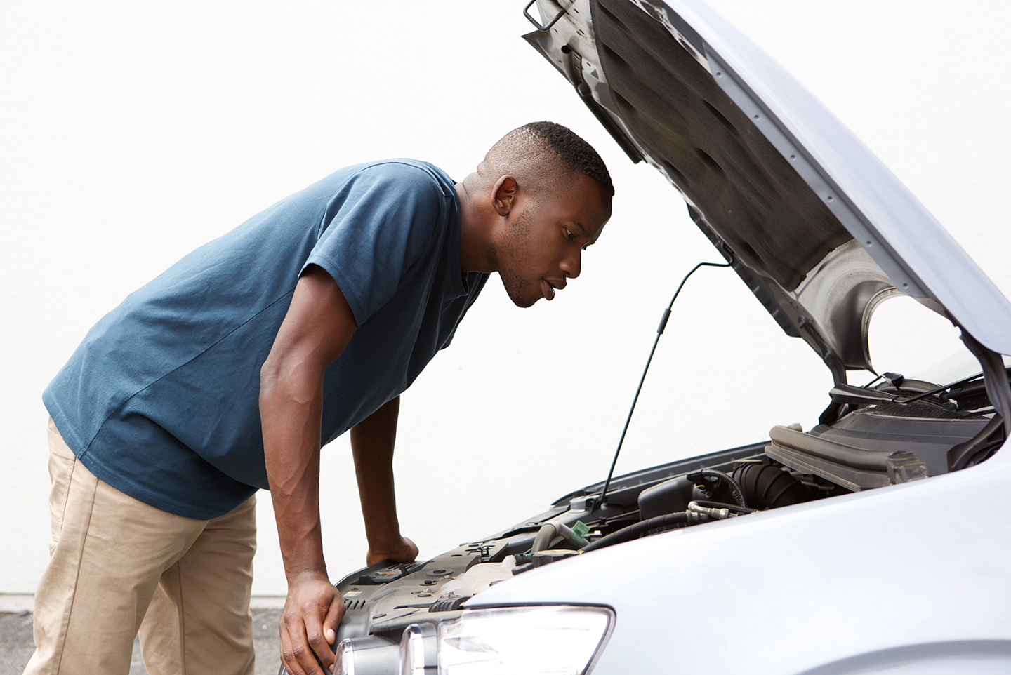 Man looking at car engine