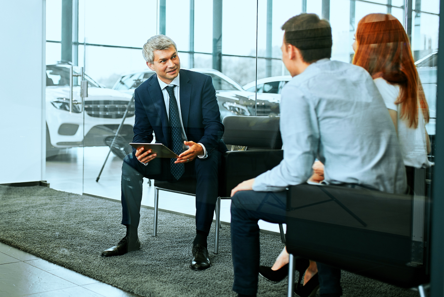 Couple talking to dealership representative