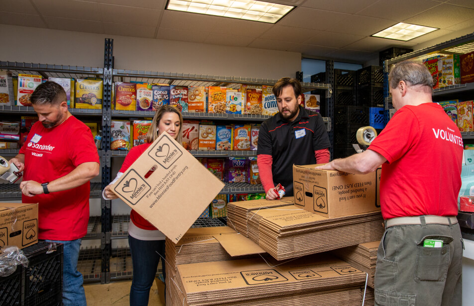 A group of Santander Consumer USA volunteers at a food bank, helping.
