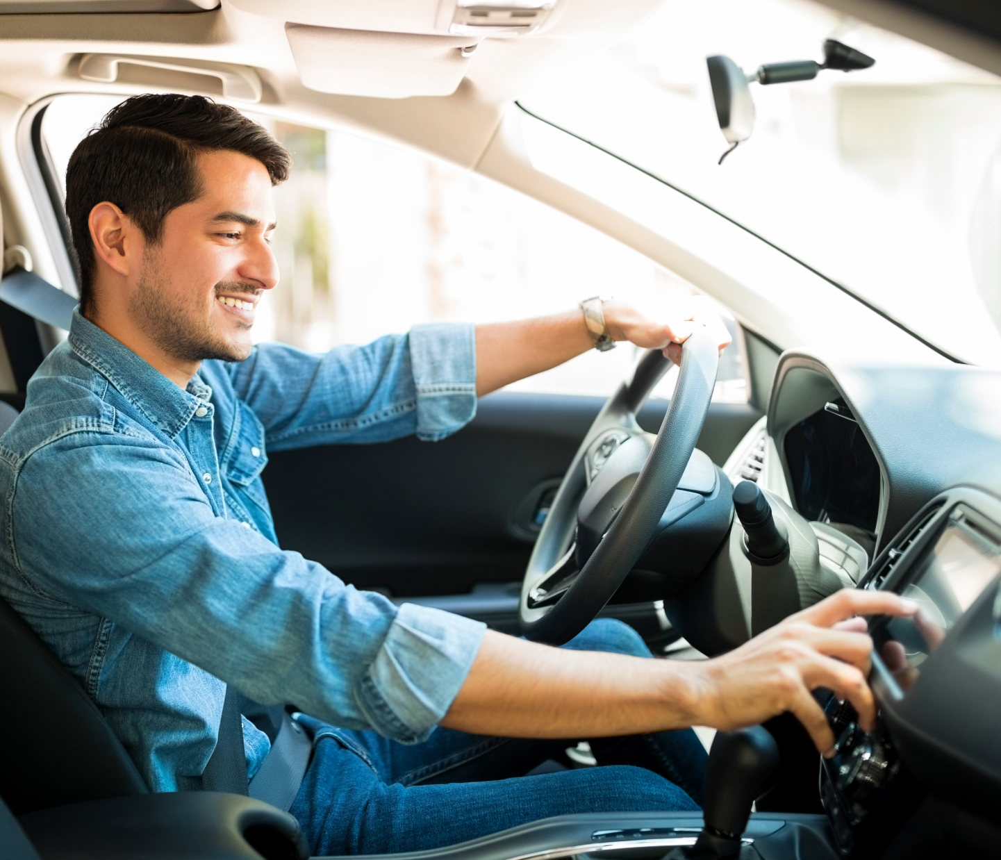 Man in car using stereo