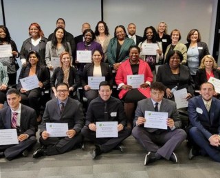 Group photo of happy trainees with certificates