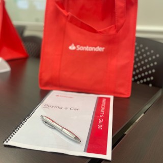 Buying a Car guide with pen sitting on top.