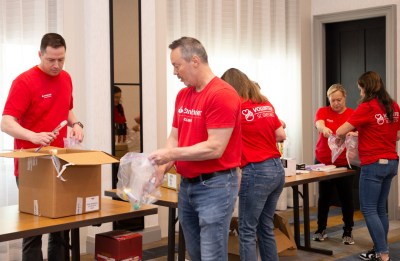 Santander Consumer volunteers pack bags and boxes for nonprofit organizations.