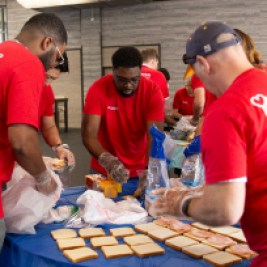 Group of Santander Consumer USA volunteers making sandwiches for nonprofit organizations.