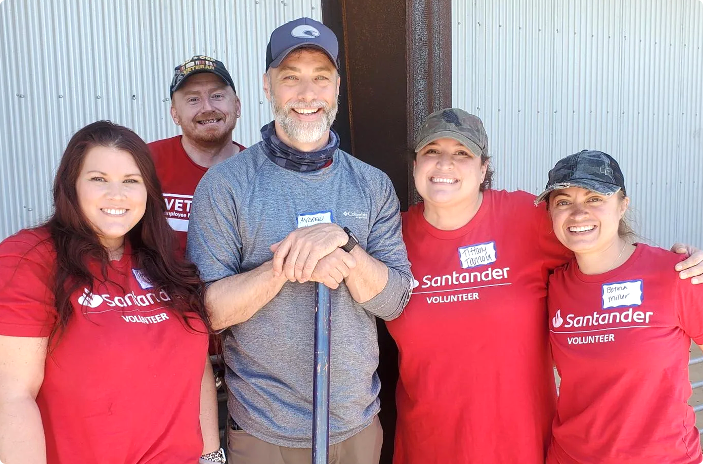 Three Santander Consumer USA volunteers are helping at an event
